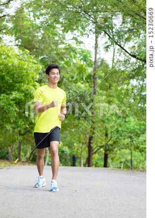 Young Chinese man running in a park 15230669