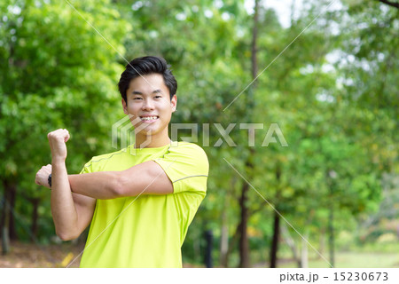 Young Chinese man warming up for exercise Young Chinese man warming up for exercise 15230673