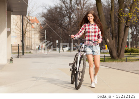 Young beautiful woman on a bicycle 15232125