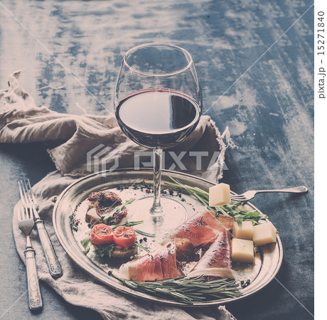 Wine appetizer set. Glass of red wine, vintage dinnerware, brushetta with cherry, dried tomatoes Wine appetizer set. Glass of red wine, vintage dinnerware, brushetta with cherry, dried tomatoes 15271840