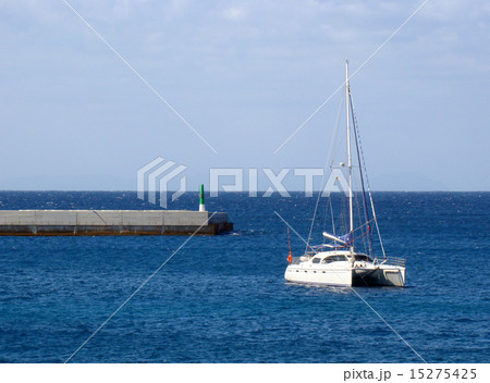Catamaran anchored near jetty Catamaran anchored near jetty 15275425
