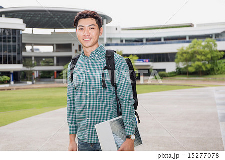 Student holding book 15277078