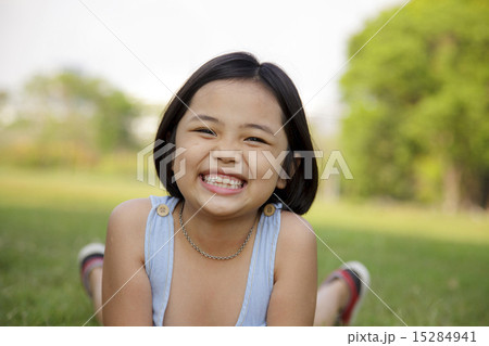 Asian little girl relax and smiling happily in the park Asian little girl relax and smiling happily in the park 15284941