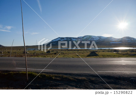 Sun shining on the road through mountain plateau Sun shining on the road through mountain plateau 15290822