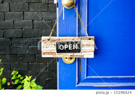 open label hanging on blue door in garden open label hanging on blue door in garden 15296824