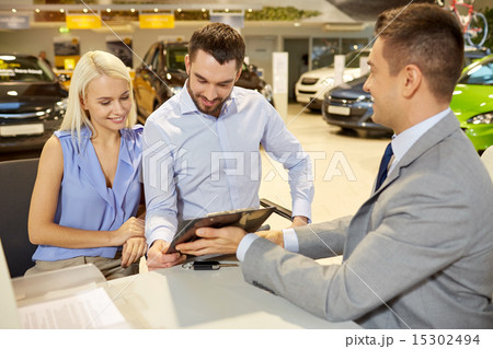 happy couple with car dealer in auto show or salon happy couple with car dealer in auto show or salon 15302494