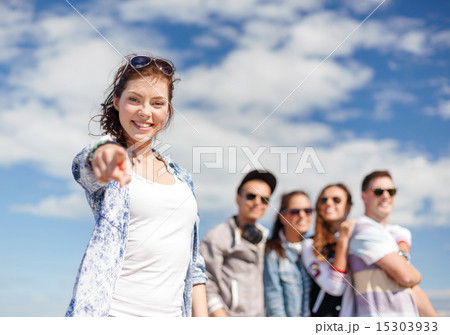 teenage girl with headphones and friends outside teenage girl with headphones and friends outside 15303933