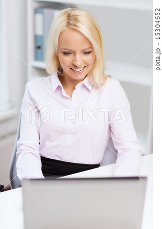 smiling businesswoman or student with laptop smiling businesswoman or student with laptop 15304652
