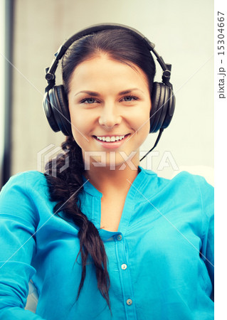 happy teenage girl in big headphones 15304667