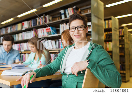 happy student boy reading books in library happy student boy reading books in library 15304891