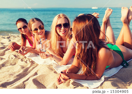 group of smiling women in sunglasses on beach group of smiling women in sunglasses on beach 15304905