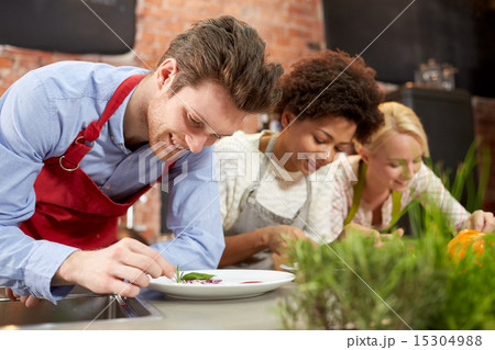 happy friends cooking and decorating dishes happy friends cooking and decorating dishes 15304988