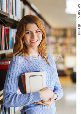 happy student girl or woman with book in library happy student girl or woman with book in library 15305189