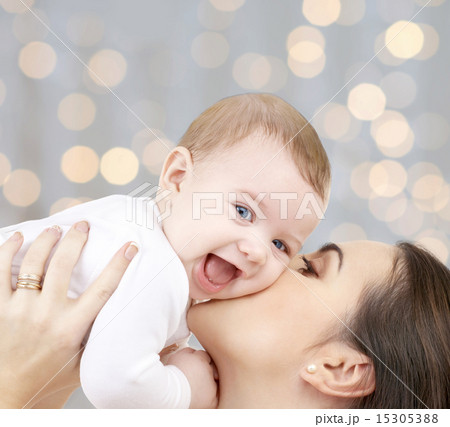 happy mother with baby over lights background 15305388