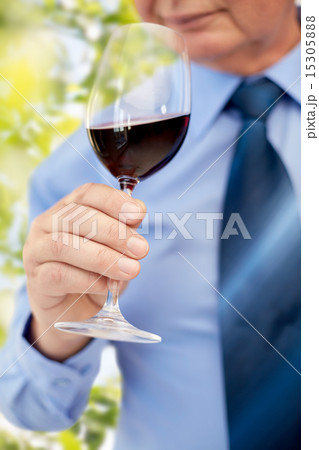close up of senior man drinking wine from glass 15305888