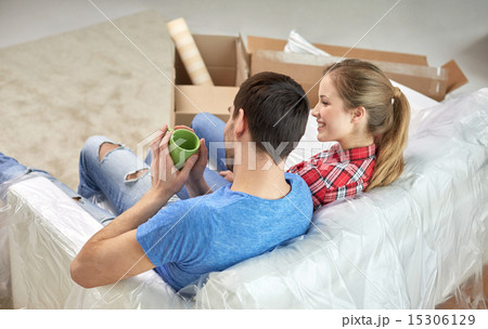 happy couple relaxing on sofa in new home 15306129