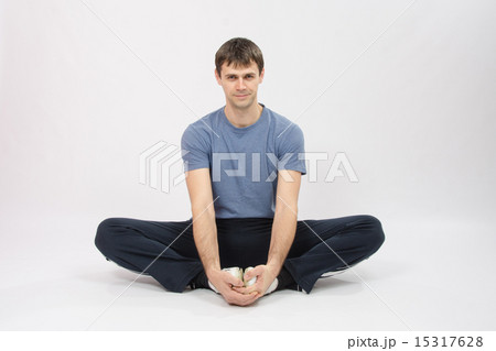 Athlete sitting holding hands your feet Athlete sitting holding hands your feet 15317628