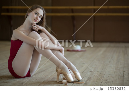 Portrait of a young ballerina sitting on the floor Portrait of a young ballerina sitting on the floor 15380832