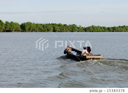 Vietnamese man rides a boat Vietnamese man rides a boat 15383376
