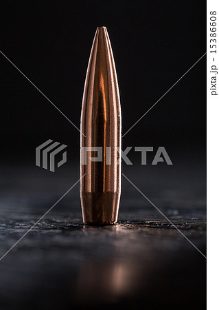 One copper bullet with bright reflections One copper bullet with bright reflections 15386608