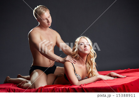 Studio shot of man makes erotic massage to blonde Studio shot of man makes erotic massage to blonde 15388911