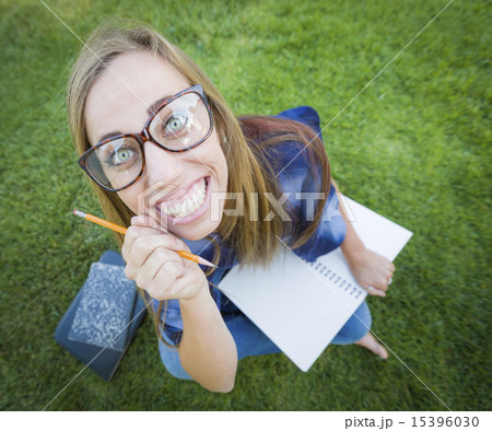 Wide Angle of Young Woman with Books and Pencil 15396030