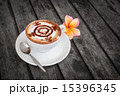 Plumeria flower on wood and glass coffee latte. 15396345