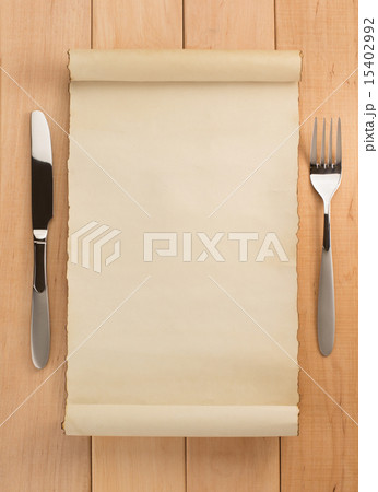 parchment and fork with knife on wood 15402992