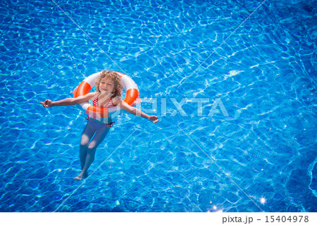 Happy child playing in swimming pool Happy child playing in swimming pool 15404978