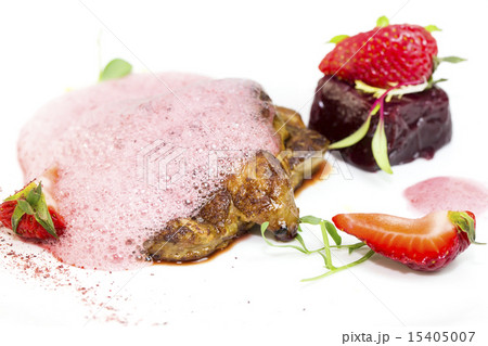 Roast goose liver is decorated with greens and str 15405007