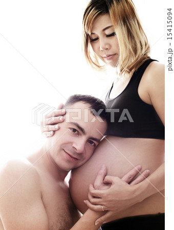 Husband listening the belly of his pregnant asian  15415094
