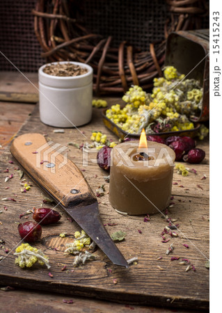 medicinal herb and burning candle 15415243