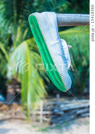 Sneakers hang on a wooden 15418360