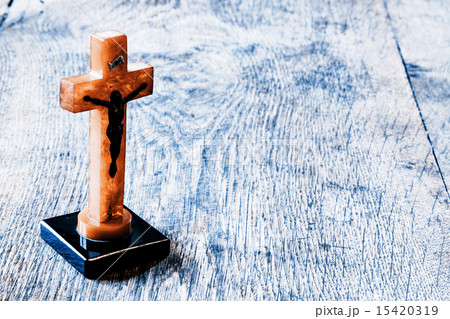 Beautiful old cross with jesus on old wood floor Beautiful old cross with jesus on old wood floor 15420319