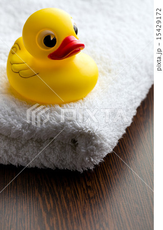 yellow bath duck on white towel yellow bath duck on white towel 15429172