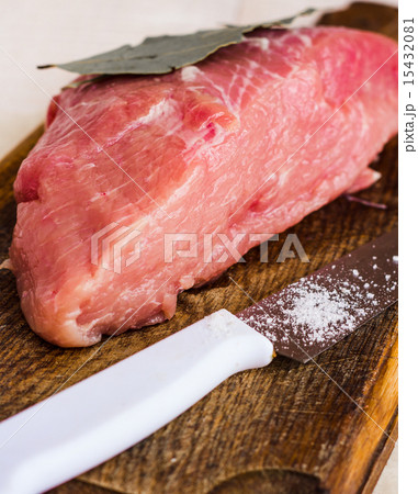 raw meat on a cutting board with spices, knife 15432081