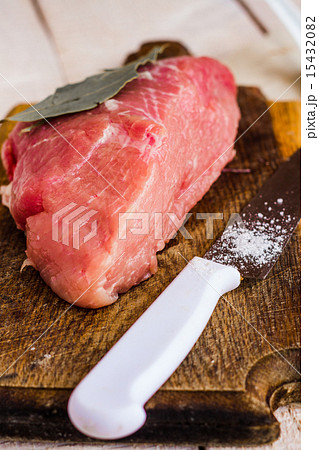 raw meat on a cutting board with spices, knife 15432082