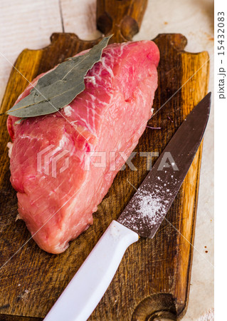 raw meat on a cutting board with spices, knife raw meat on a cutting board with spices, knife 15432083