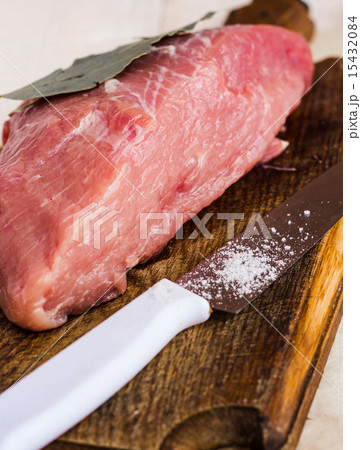 raw meat on a cutting board with spices, knife 15432084