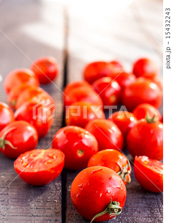 juicy tomatoes cherry on dark wooden board juicy tomatoes cherry on dark wooden board 15432243