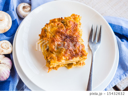 eating a piece of meat lasagna with mushrooms eating a piece of meat lasagna with mushrooms 15432632