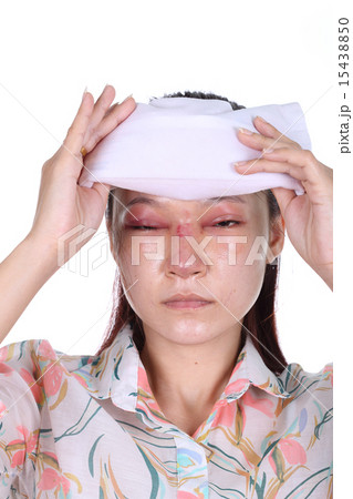 Woman holds an ice pack after nose job 15438850