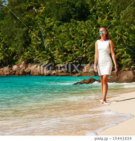 Woman wearing dress on beach at Seychelles Woman wearing dress on beach at Seychelles 15441834