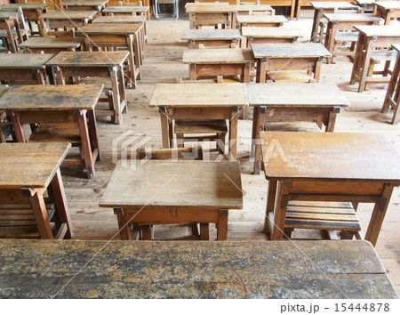 教壇から見る木製の古い机と椅子が並ぶ教室の写真素材