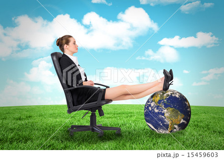 Composite image of businesswoman sitting on swivel chair with fe 15459603