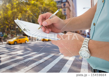 Composite image of delivery man writing on clipboard 15459664