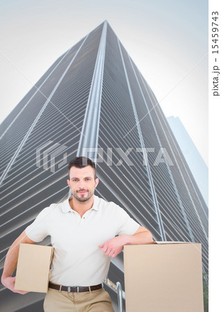 Composite image of delivery man with trolley of boxes 15459743