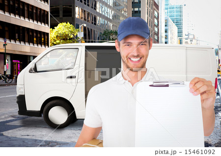 Composite image of happy delivery man holding cardboard box and Composite image of happy delivery man holding cardboard box and 15461092