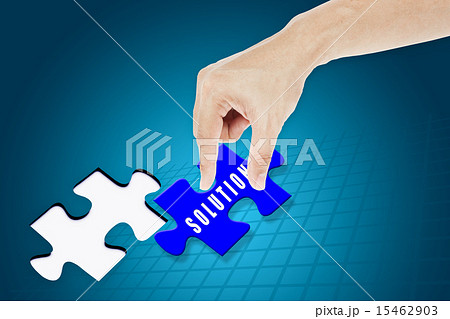 Hand inserting missing solution jigsaw puzzle 15462903