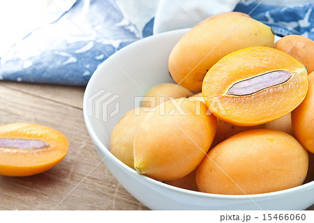 Sweet Marian plum fruit in bowl on wooden Sweet Marian plum fruit in bowl on wooden 15466060